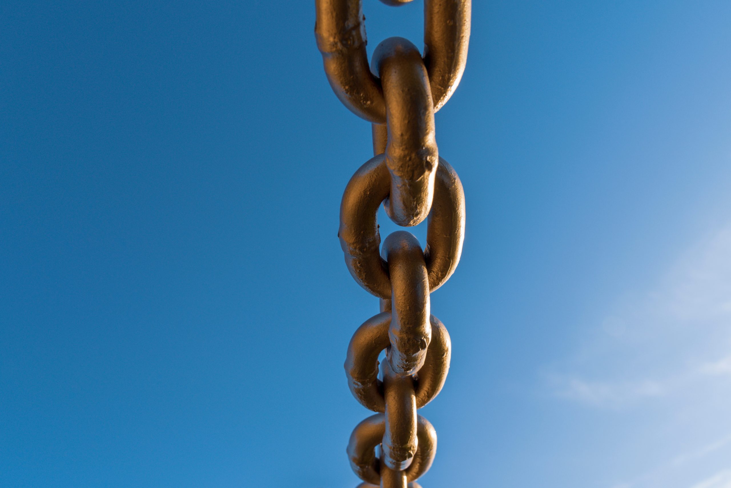 a golden chain link against the sky, representing behavior chain analysis