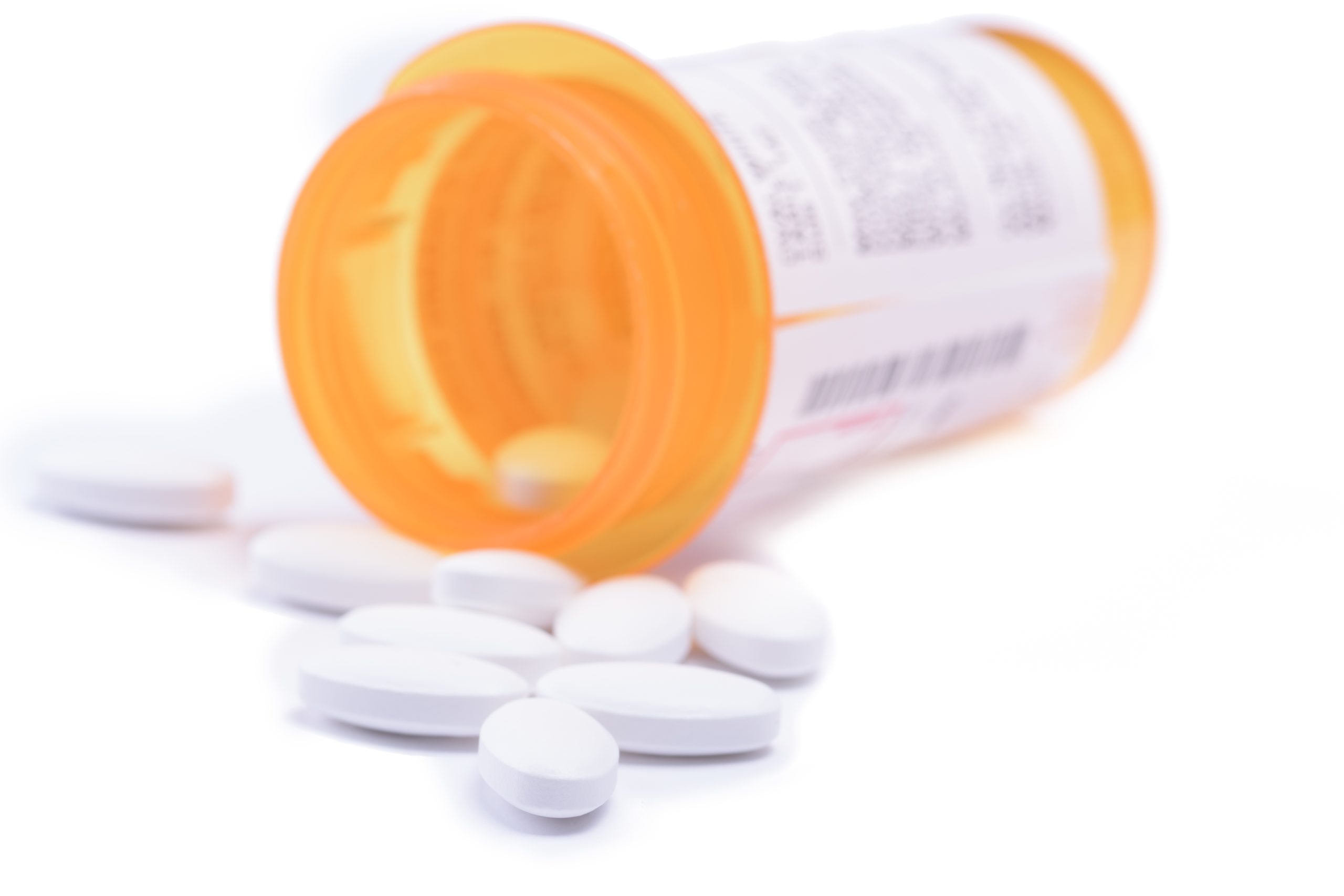 a pill bottle with benzodiazepines spilling out