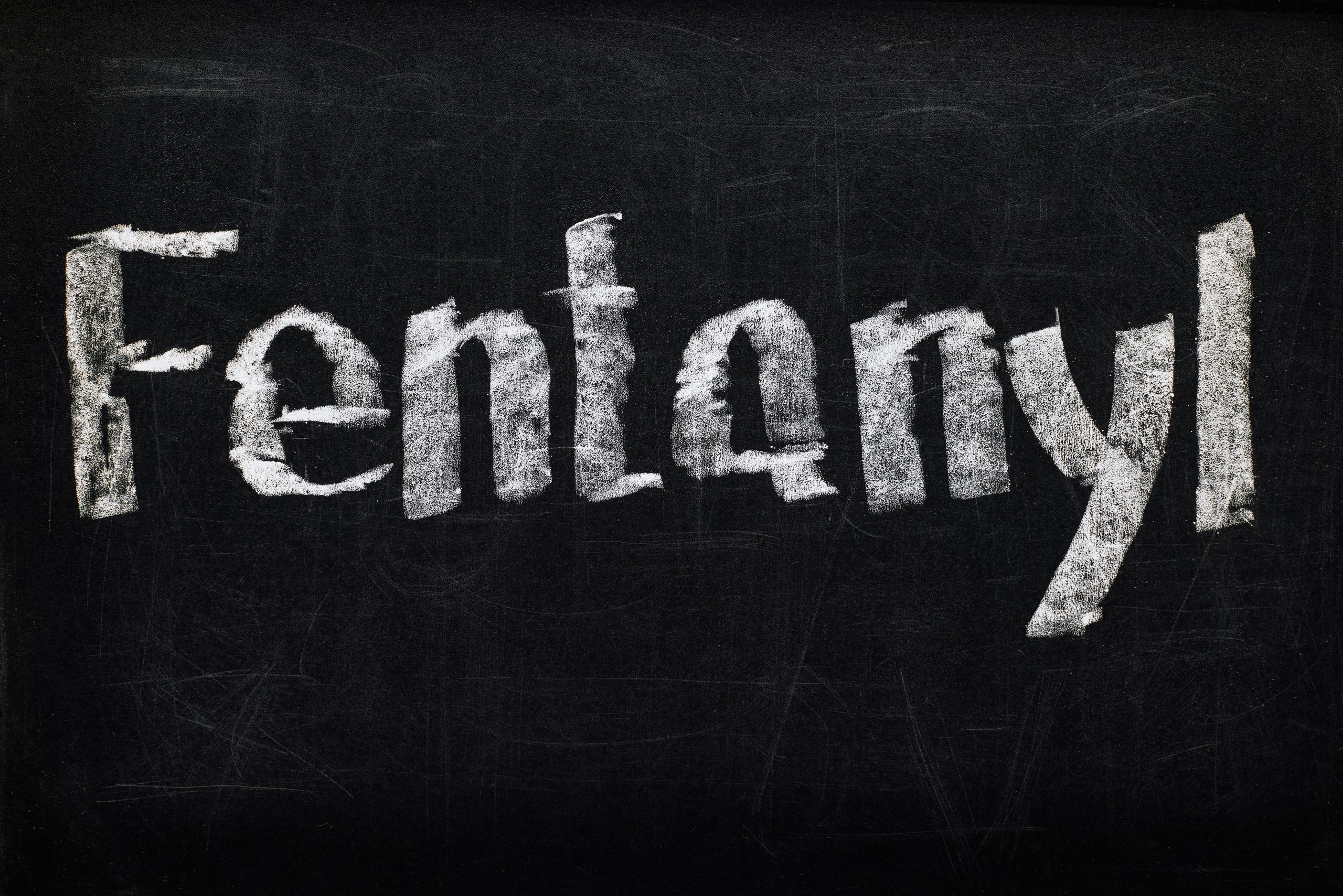 the word "fentanyl" written in chalk on a blackboard, highlighting the importance of fentanyl awareness