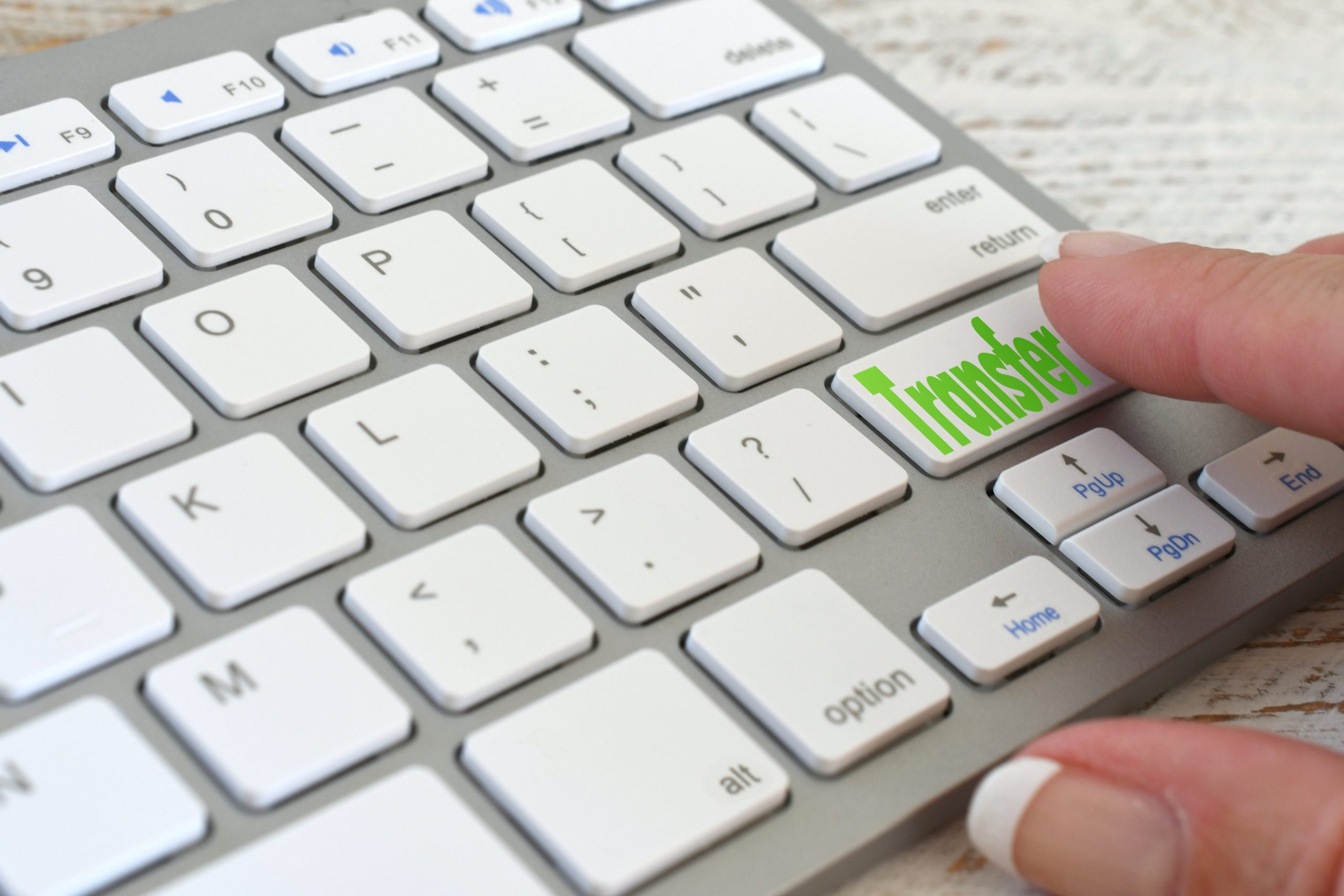 a woman pressing a "transfer" button on a keyboard, symbolizing transfer addiction