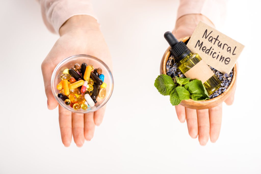 a woman holding bowls in each hand, one with pills and the other with natural medicine, highlighting the need for a natural alternative to adderall