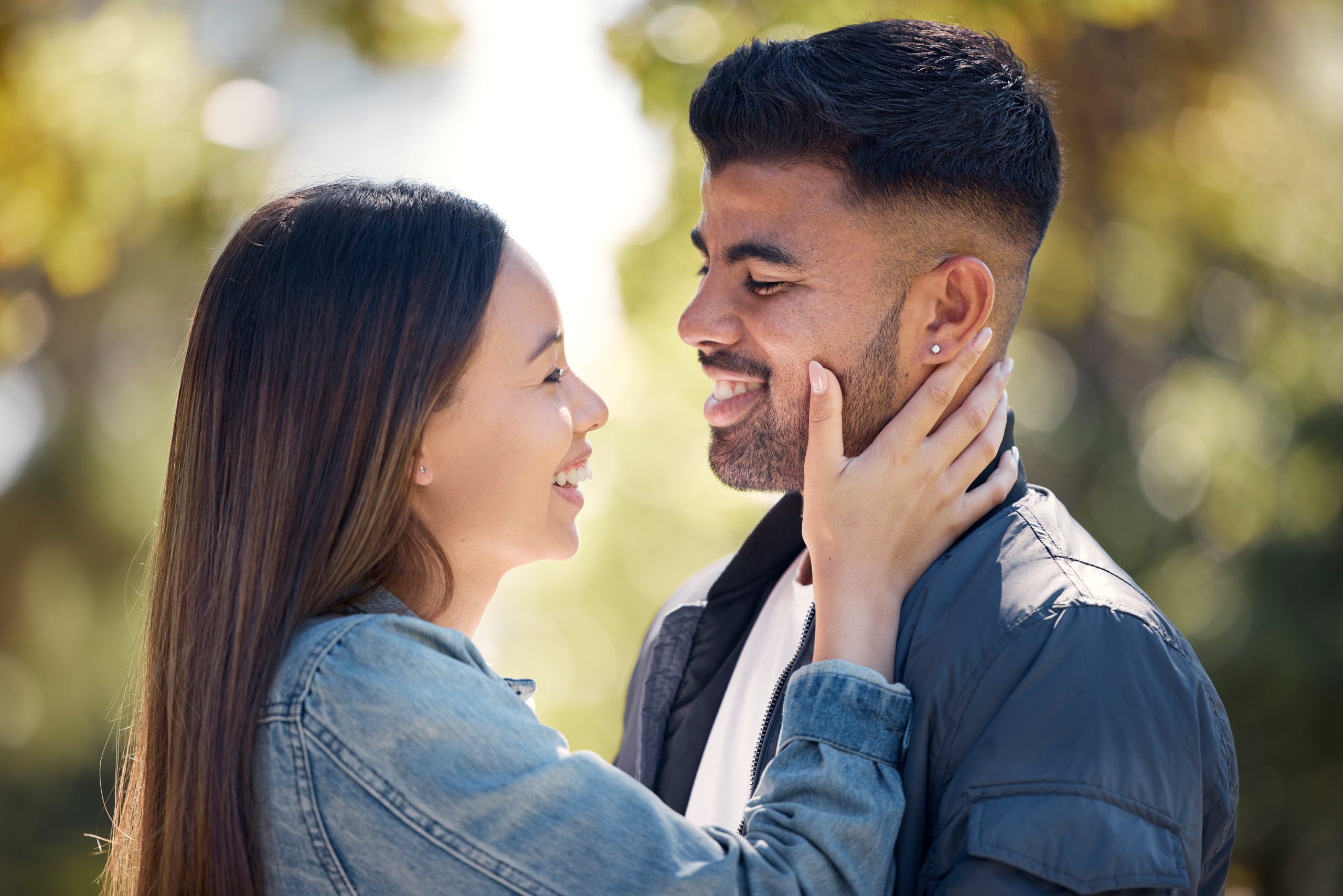 a couple outdoors with the girl putting her hand on the man's face, showing that dating in recovery is possible