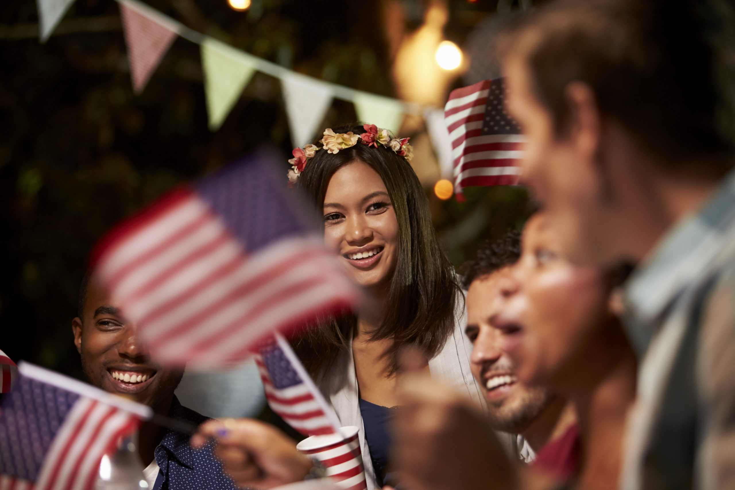 people waving American flags as they celebrate a sober 4th of July