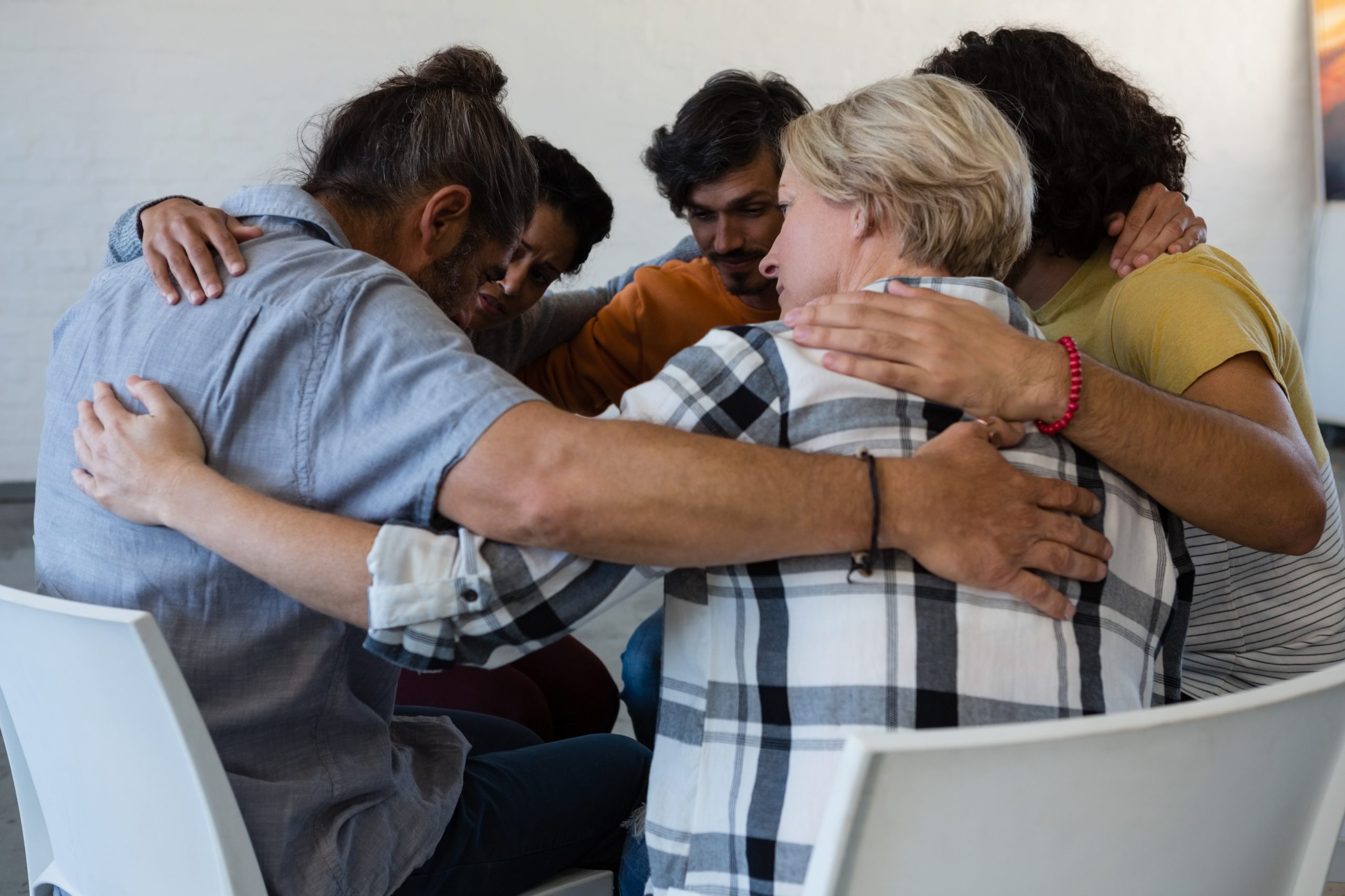 people huddling in a circle as part of forgiveness in recovery