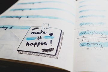 notes in a journal with one reading "make it happen" to show how to wean off alcohol safely